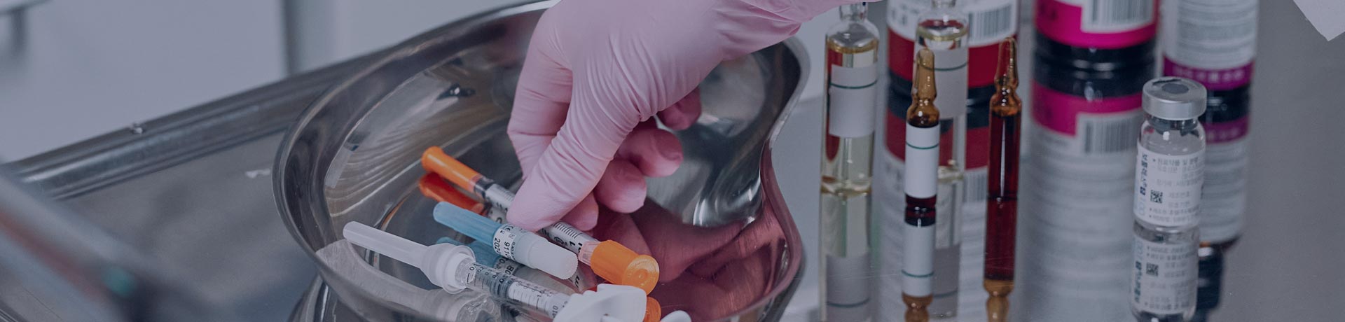 Hands on laboratory test tubes, syringes and basket