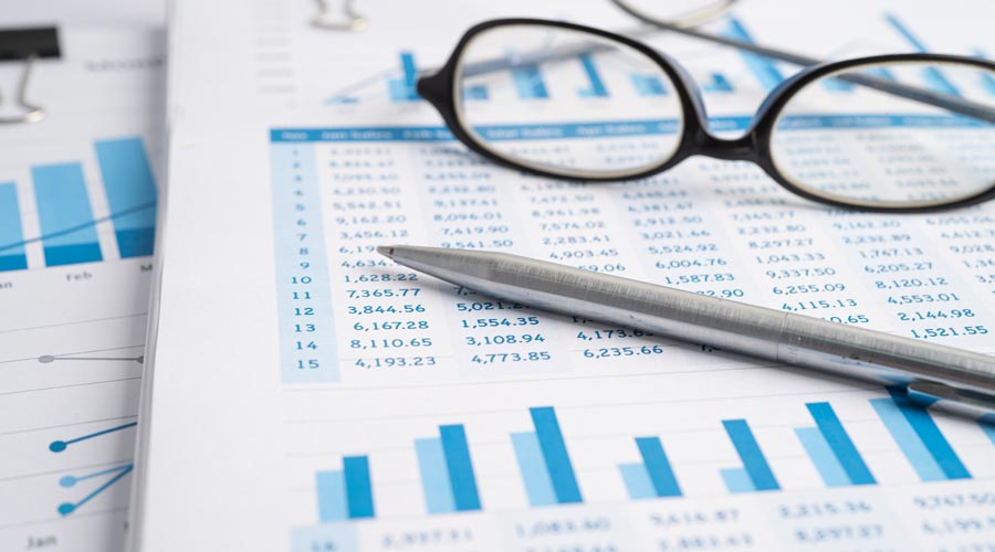 glasses and pen on a sheet of paper