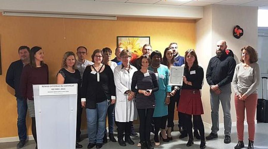 un groupe d'employés de l'hôpital se réunit, dont l'un d'entre eux tient une certification