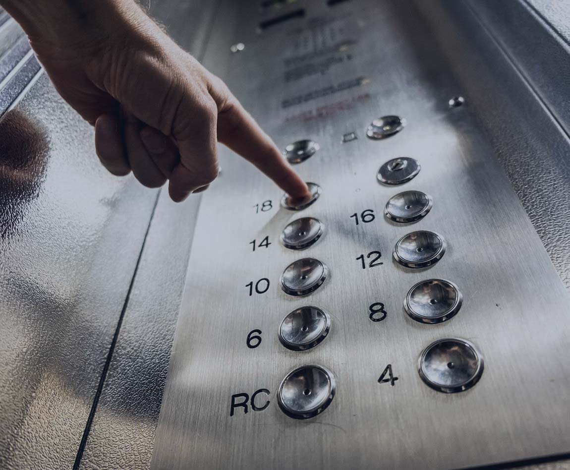 man pressing elevator buttons