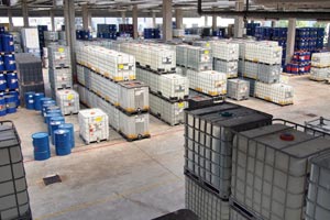 warehouse with chemical goods in containers and barrels