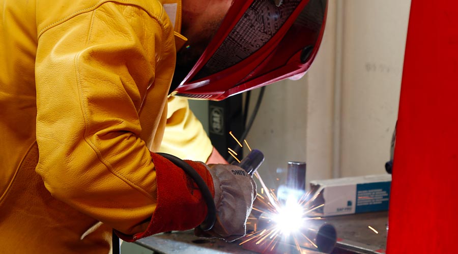 technician doing a weld with his protective mask