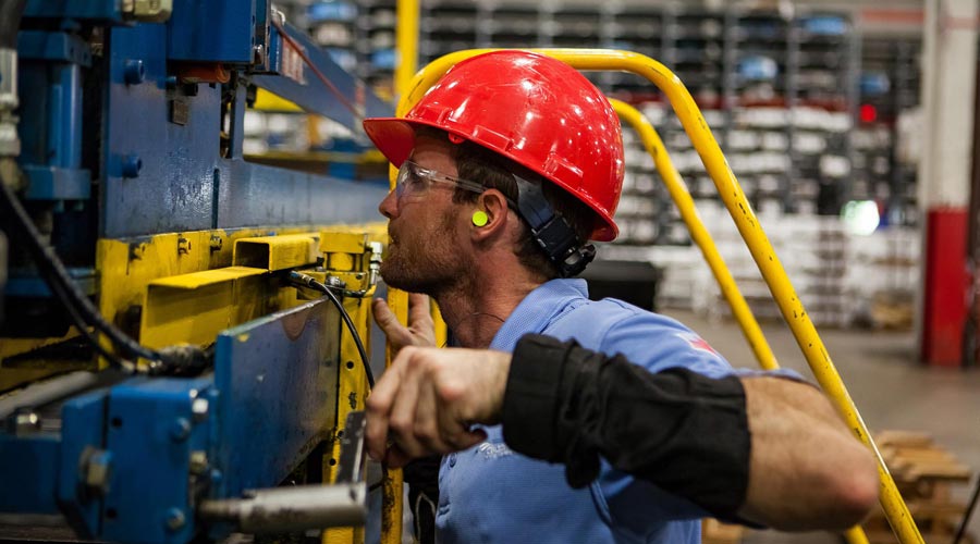 worker with protective equipment in a factory