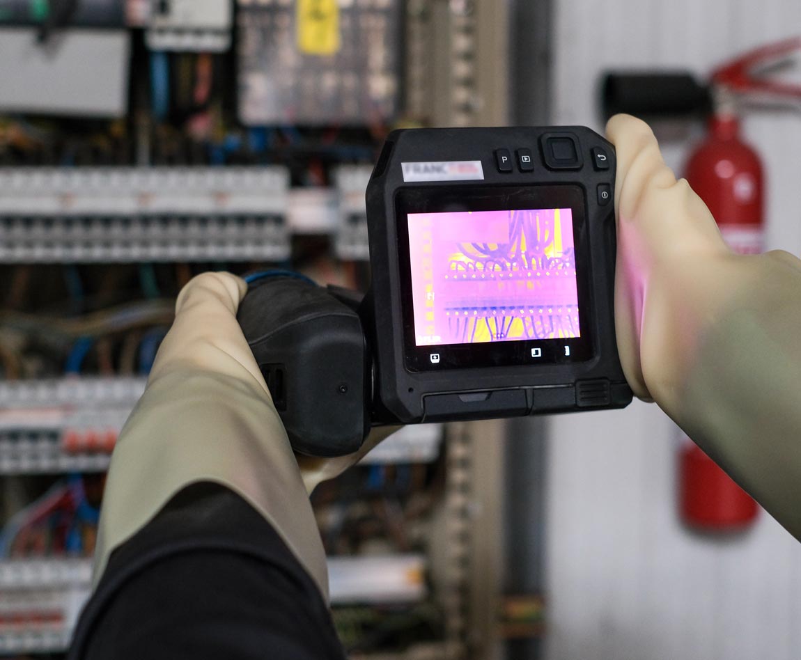thermographer inspecting an electrical panel