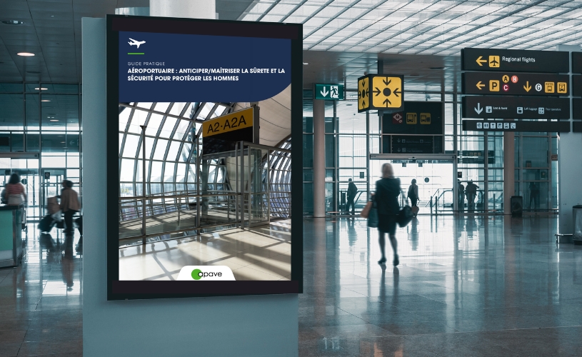 Une affiche représentant le guide sectoriel Apave dans un hall d'Aéroport