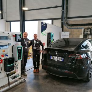 Deux collaborateurs Apave devant un véhicule électrique