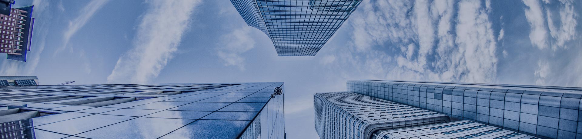 buildings seen from the ground in perspective with the sky