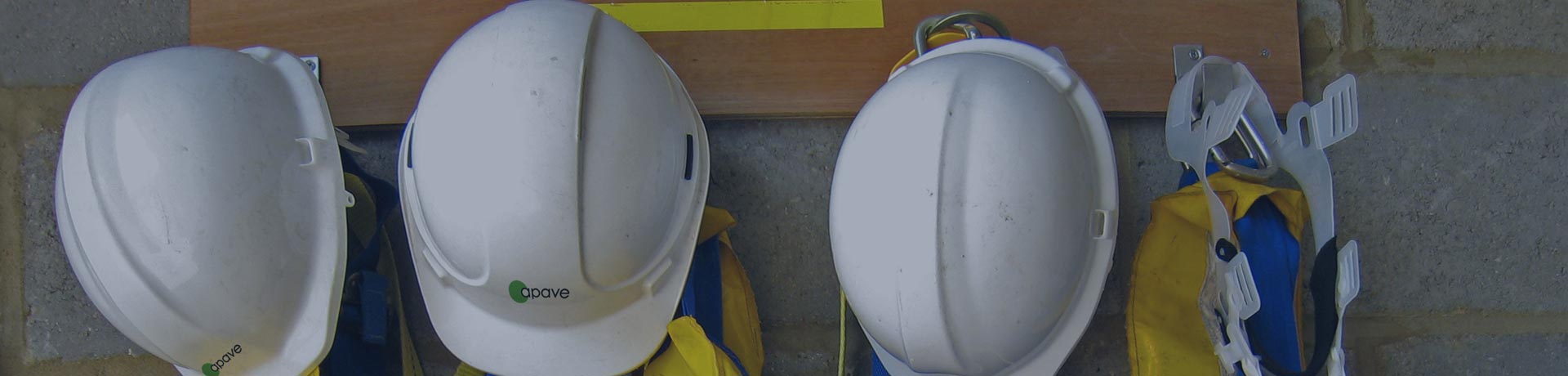 helmets and construction equipment hung in a locker room