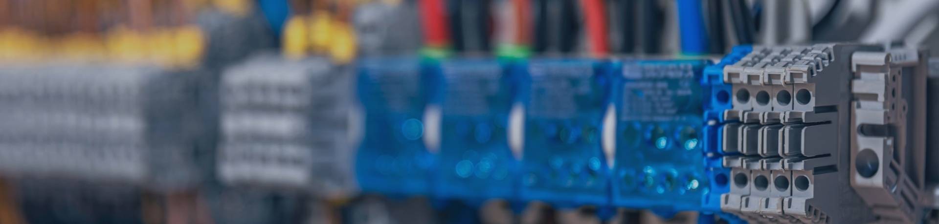 Close-up of an electrical control panel with various wires and terminals, highlighting electrical engineering and automation.