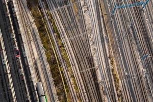 Aerial view of multiple converging railway tracks, symbolizing logistics, transportation, and industrial infrastructure.