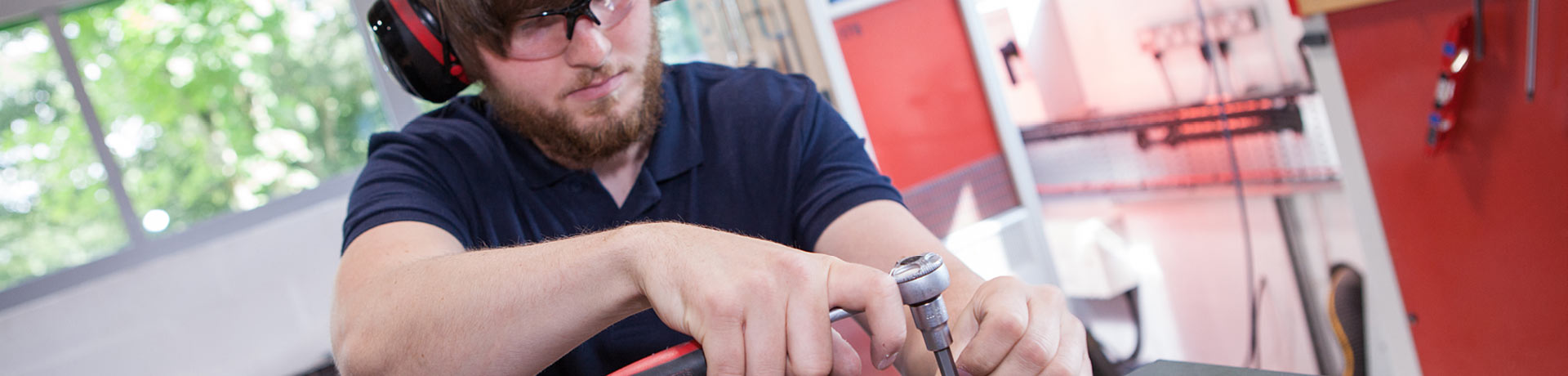 A man works on an electro-dynamic exciter