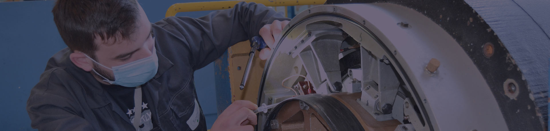 A man performs a maintenance operation on an equipment