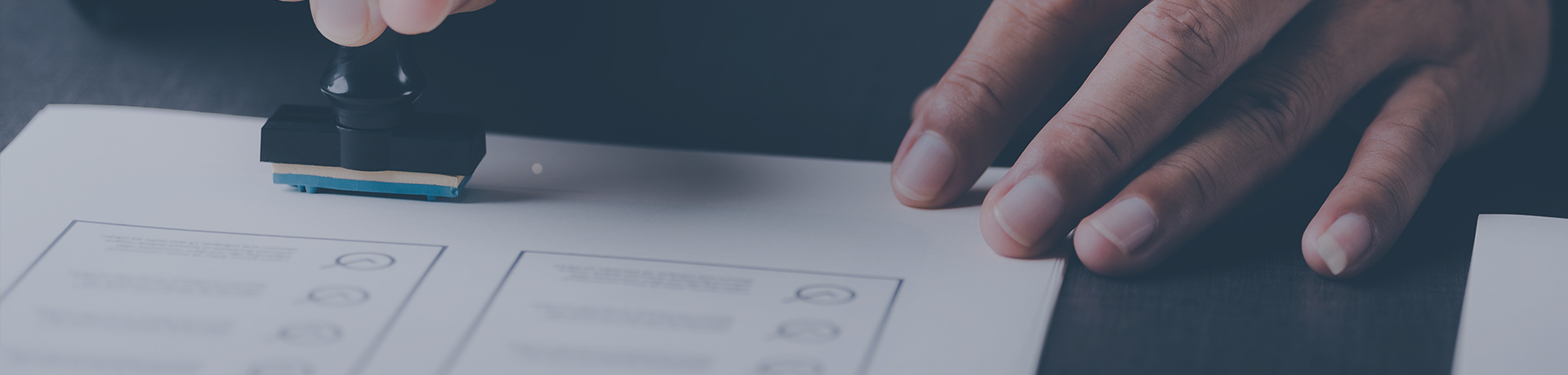 A person stamping a sheet to validate the accreditations