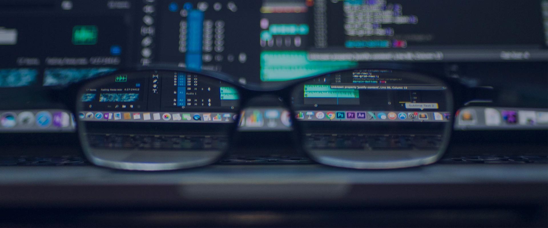 glasses in front of an encrypted computer screen