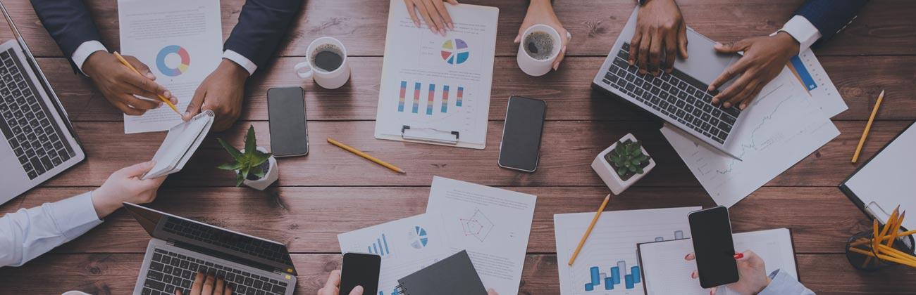 Top view of a meeting table with people working