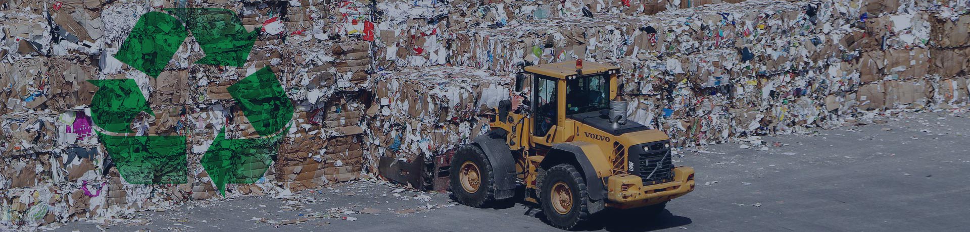 bulldozer carrying recycled paper